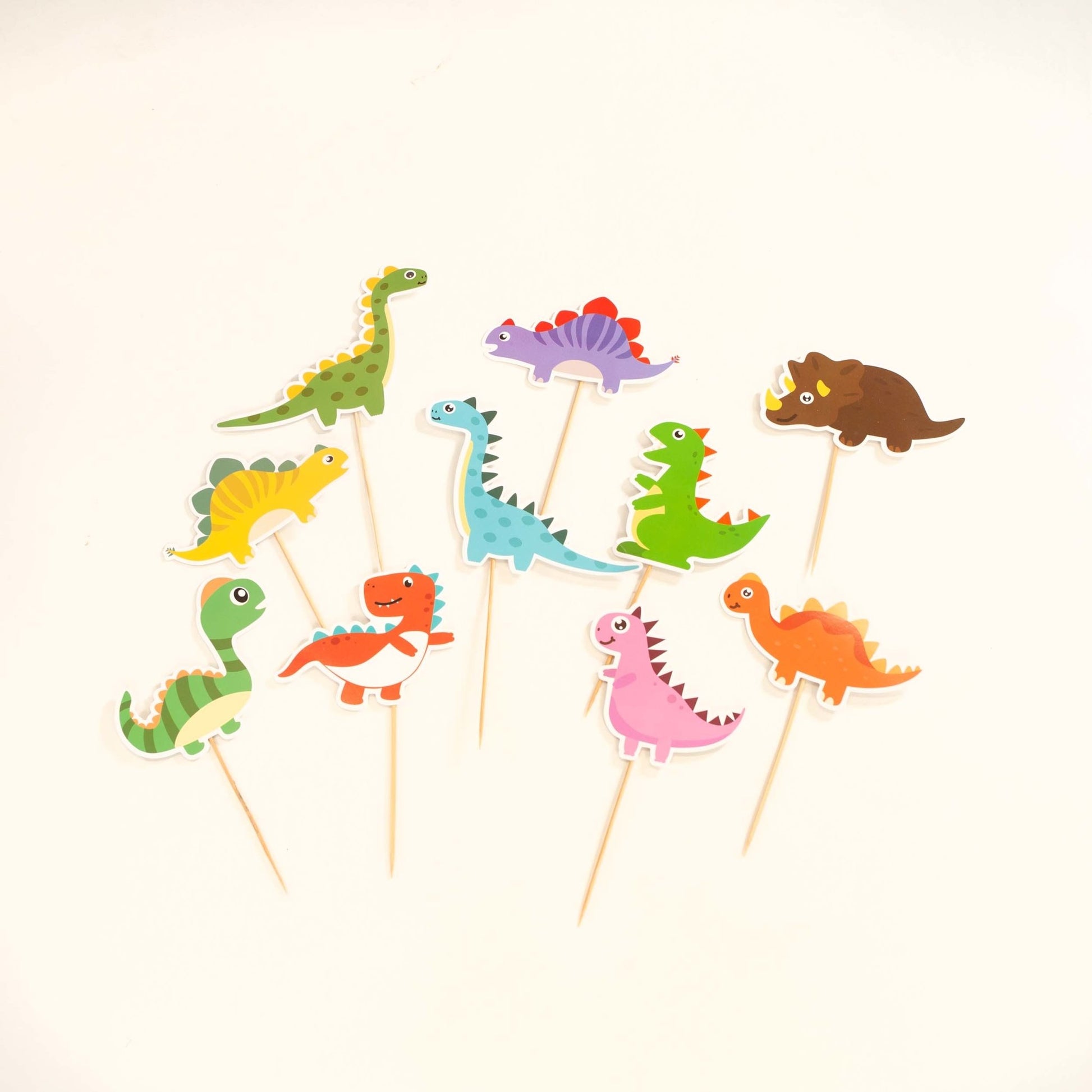 https://www.elliesparty.com/cdn/shop/products/dinosaur-party-cake-toppers-set-of-10-166374.jpg?v=1684344632&width=1946